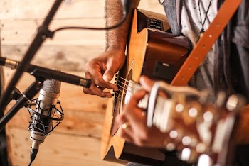 Person Playing Acoustic Guitar