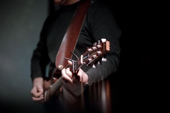 person playing brown guitar