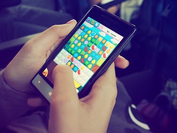 Person Playing Candy Crush on Nokia Smartphone