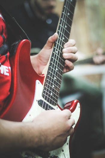 Person Playing Electric Guitar