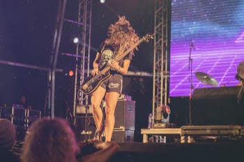 Person Playing Electric Guitar on Stage