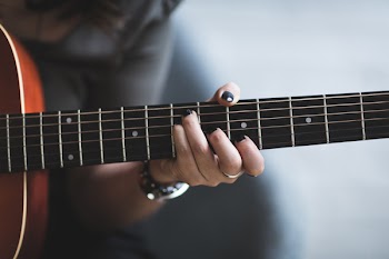 Person Playing Guitar