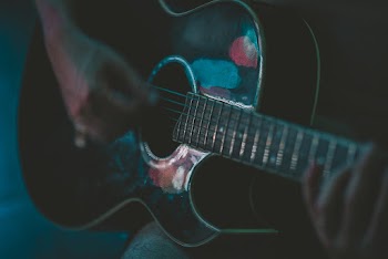 Person Playing Guitar