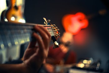 Person Playing Guitar
