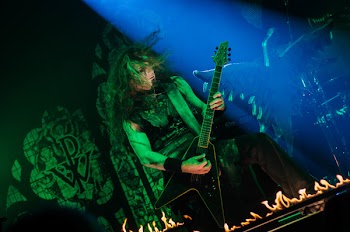Person Playing Guitar on Stage With Light Ray