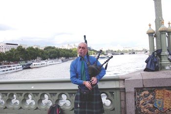 Person Playing Instrument on Bridge