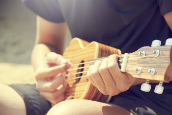Person Playing Ukulele