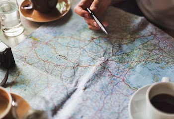person plotting in map