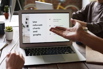 Person Pointing at Laptop Screen
