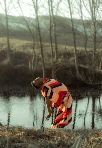 Person Posing Near Body of Water