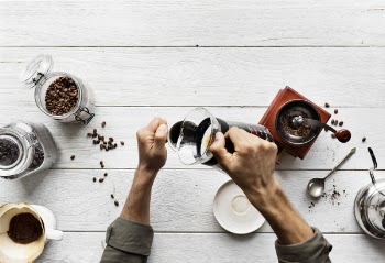 Person Pouring Coffee In A Mug