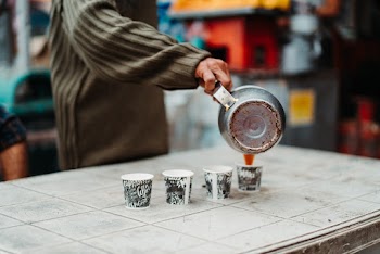Person Pouring Coffee on a Mug