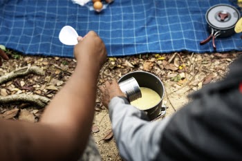 Person Pouring Milk on Caserole
