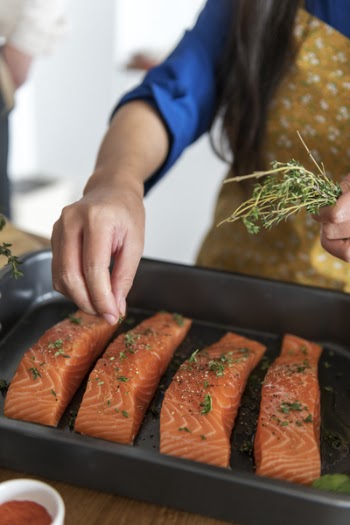 Person Pouring Seasonings on Raw Meats