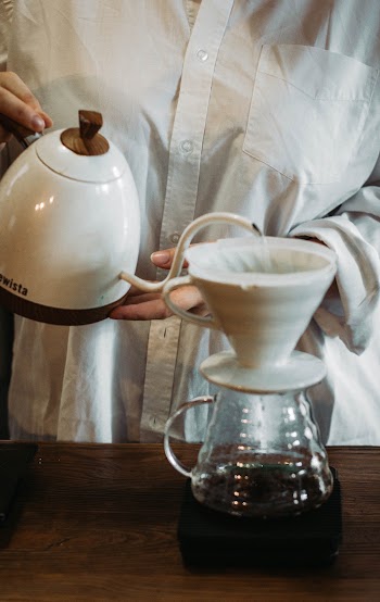 Person Pouring Water in a Cup Close-up Photography