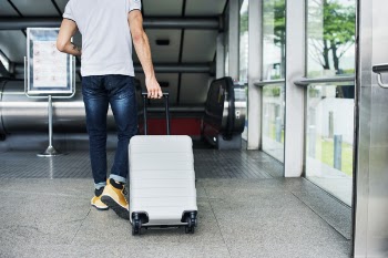 Person Pulling Travel Luggage