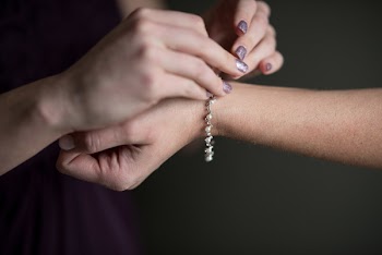 Person Putting Beaded Pearl Bracelet