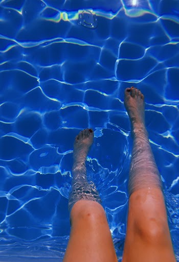 Person Putting Feet In Body Of Water