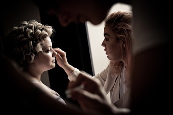 Person Putting Makeup On Woman