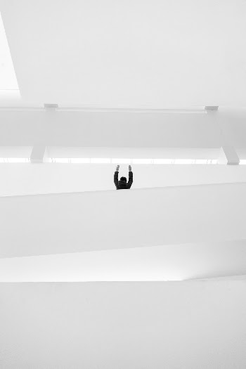 Person Raising Both Hands Inside Building