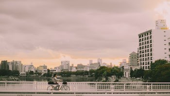 person riding bike on bridge