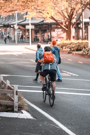 Person Riding Bike on Street