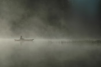 Person Riding Boat on Body of Water