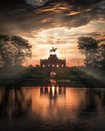 Person Riding Horse Statue during Golden Hour