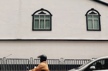 Person Riding Motorcycle Near Building
