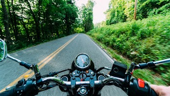 Person Riding Motorcycle on Road