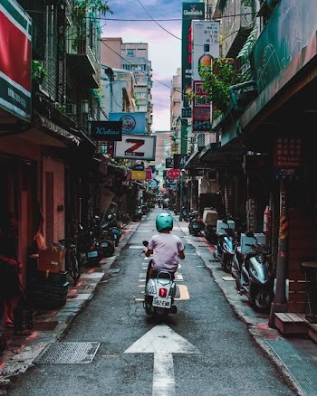 Person Riding Motorcycle on Street