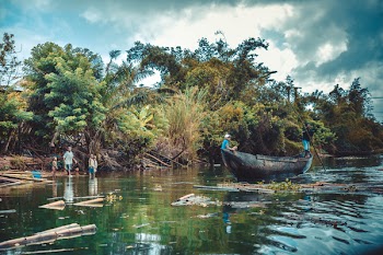 Person Riding on Black Wooden Boat
