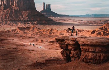 person riding on horse near cliff
