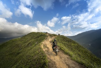 Person Riding on Motorcycle on Mountain