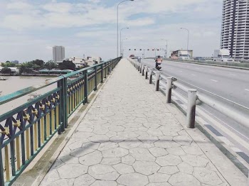 Person Riding on Motorcycle Passing by Concrete Pavement