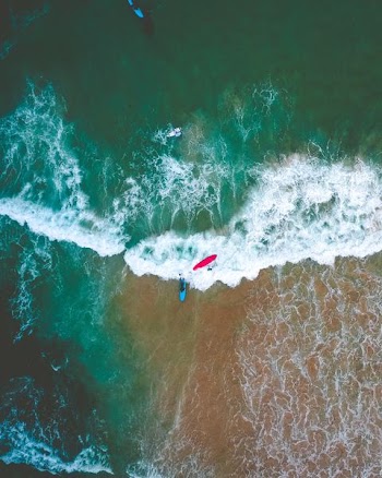 person riding on surfboard while surfing