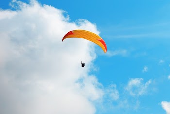 Person Riding Parachute 