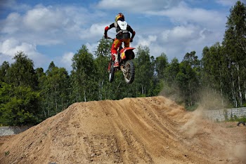 Person Riding Red Dirk Bike Mid Air Ramping