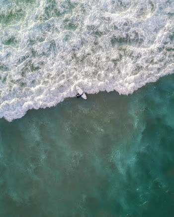 Person Riding Surfboard