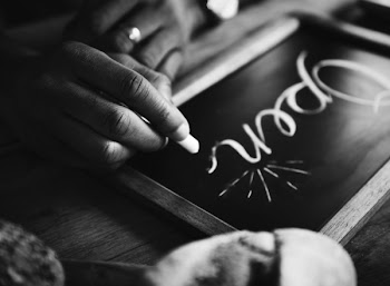 Person Righting On Chalkboard