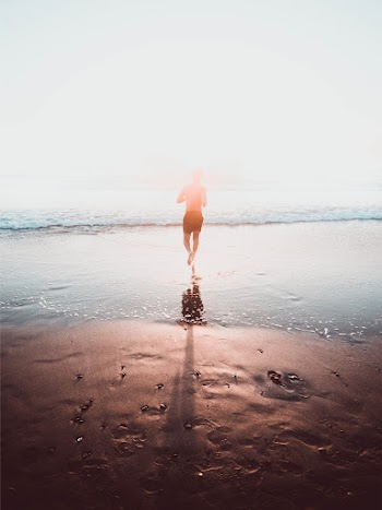Person Running Towards Sea