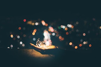 person's hand with light bokeh