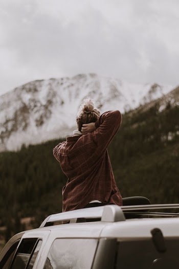 Person Seating on Vehicle Roof