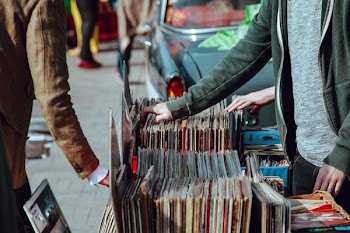 person selling vinyl album in street