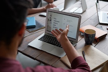 Person Sharing Ideas on Laptop