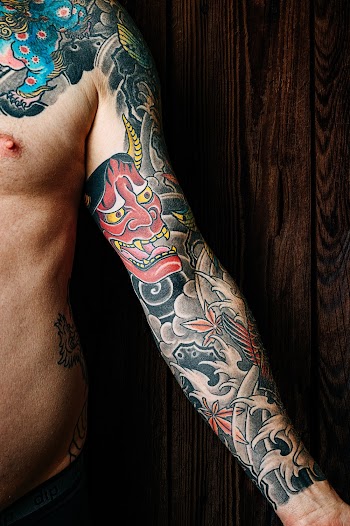 Person Showing His Tattoo