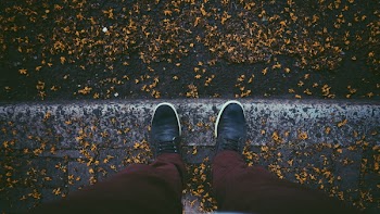 Person Showing Pair of Black Shoes