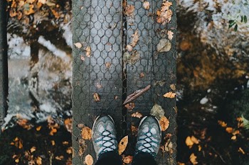 person showing pair of gray shoes