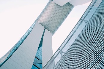 person showing white concrete building