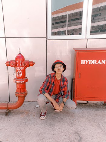 Person Siting Beside Fire Hydrant